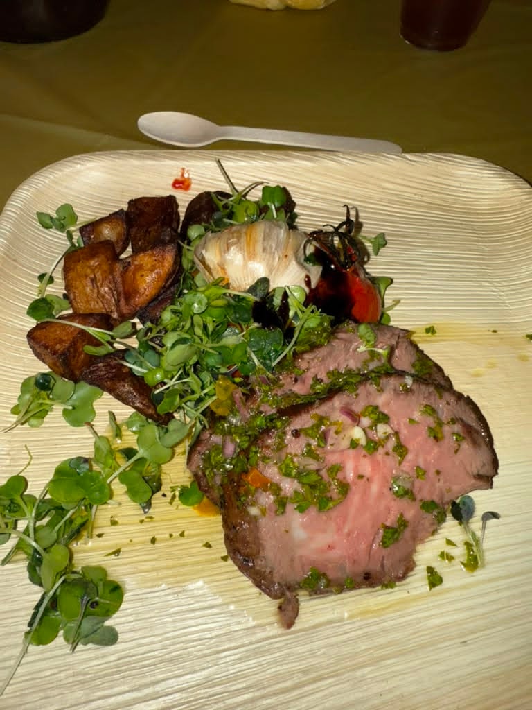 Gourmet plated dinner at the 2026 Arizal Siyum — seared meat with roasted potatoes and microgreens